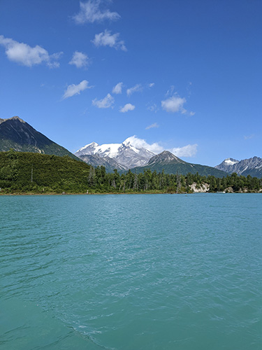 Mt. Redoubt over vibrant blue Crescent Lake in Lake Clark National Park