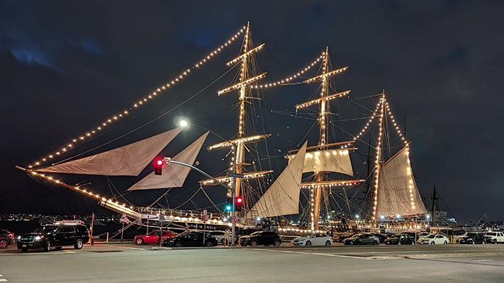 The Star of India sailing ship outlined with white Christmas lights