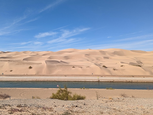 Imperial Sand Dunes behind a manmade canal