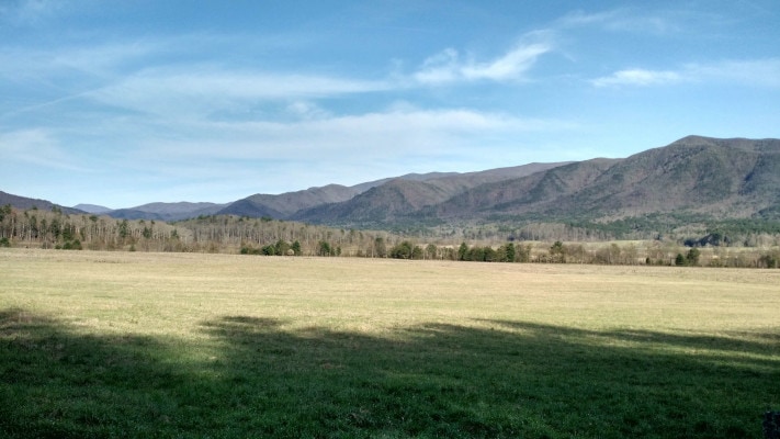 An open meadow surrounded by mountains at Cade's Cove in Great Smoky Mountains National Park