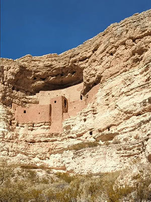 A five-story red brick "castle" built into a cliff face