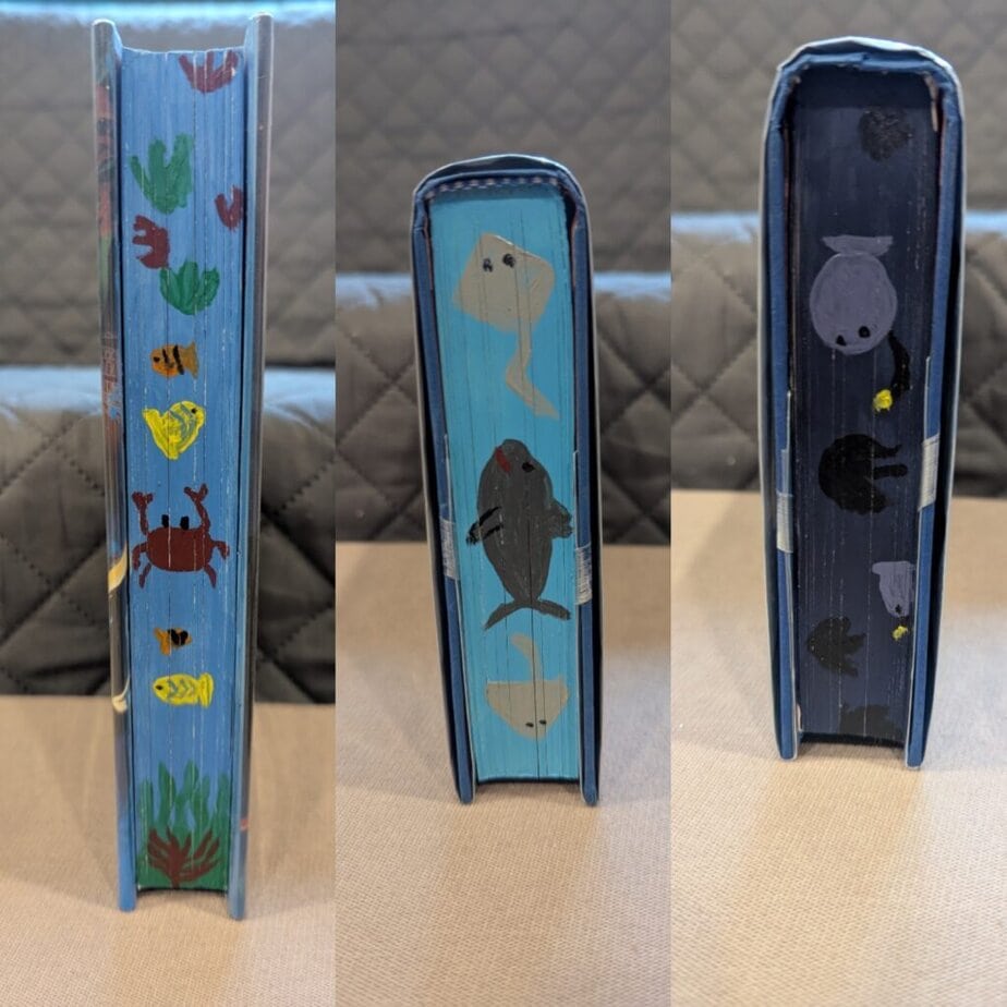 Three views of the page ends of a book, each with a different hand-painted ocean scene