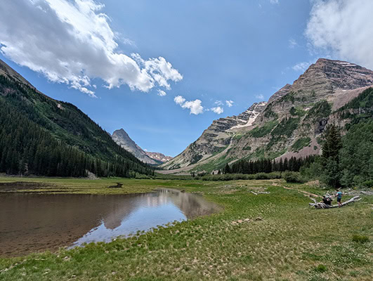 Jagged peaks are reflected in a shallow lake